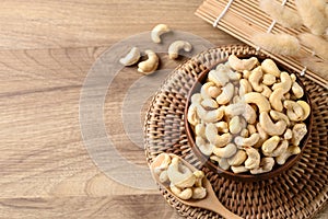 Raw cashew nuts in bowl on wooden background, Food ingredient