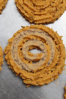 Raw chakali in plate. Indian Traditional Tea Time Snack Chakli, a deep fried snack, It is known as Chakali, Murukku, Muruku,