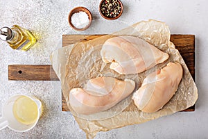 Raw chicken breast on a cutting board