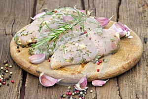 Raw chicken breast fillets with herbs and spices