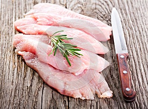 Raw chicken breast fillets with rosemary