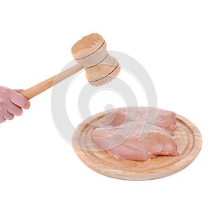 Raw chicken breast and mallet