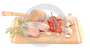 Raw chicken breast with tomatoes and mushrooms.