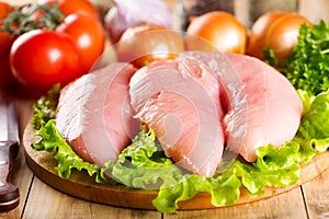 Raw chicken breast with vegetables