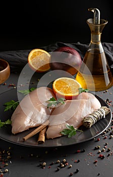 Raw chicken breasts prepared for cooking with ingredients,vertical view
