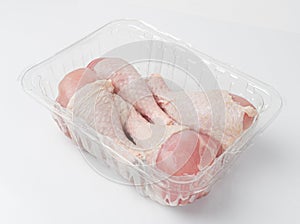 Raw Chicken Drumsticks in a Plastic Container Isolated, Uncooked Poultry Legs, Fresh Hen Meat