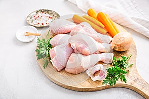 Raw chicken drumsticks with vegetables ans spices prepared for cooking photo