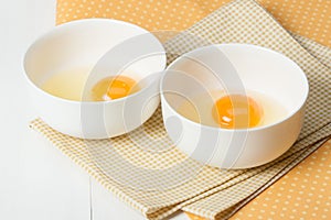 Raw Chicken Eggs In White Bowls On Cotton Napkins