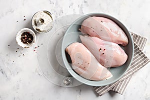 Raw chicken fillet in a bowl with spices