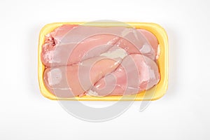 Raw chicken fillet package isolated on white background.