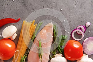 Raw chicken fillet with pasta, herbs, onions and tomatoes, mushrooms , poultry meat