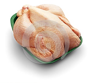 Raw chicken in a green tray over white background