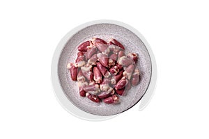 Raw chicken hearts with salt, spices and herbs