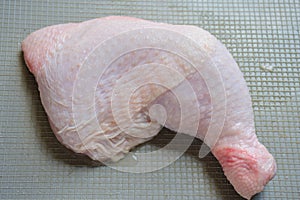 Raw Chicken Hip on plastic board