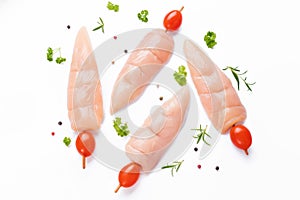 Raw chicken inner on skewers with tomatoes white background with spices, herbs.Raw uncooked Chicken meat,kebab on