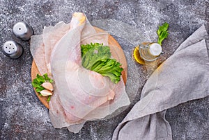 Raw chicken leg on cutting board