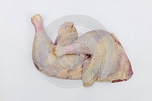 Raw chicken leg quarters on  white background.