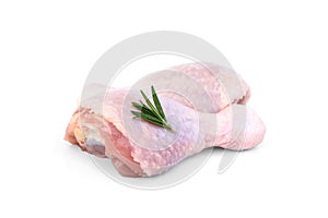 Raw chicken leg with rosemary isolated on white background.