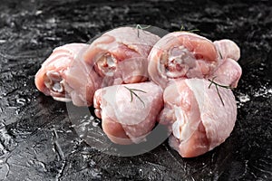 Raw chicken legs on black background