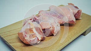 Raw chicken legs: fresh chicken on wooden plate. isolated over white background