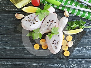 Raw chicken legs, parsley, freshness spices recipe preparation board wooden background