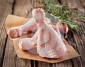 Raw chicken legs seasoned with herbs and spices