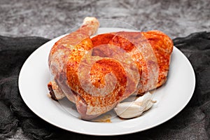Raw chicken legs with spices on plate