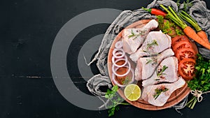 Raw chicken legs with spices and vegetables.
