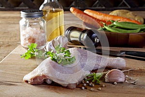 Raw chicken legs with spices and vegetables