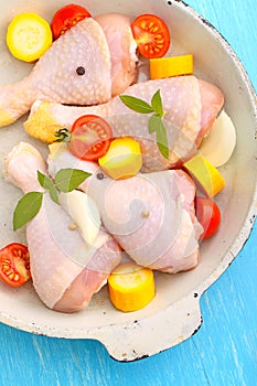 Raw chicken legs with vegetables