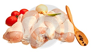 Raw chicken legs with vegetables, isolated on white background