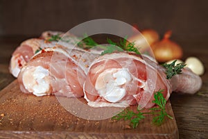 Raw chicken legs on wooden board.