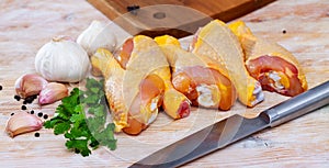 Raw chicken legs on wooden table