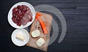 Raw chicken liver, carrots, onions, butter. Ingredients for making pate. Place for text