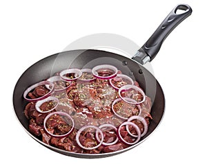 Raw chicken liver with red onion in frying pan isolated on white