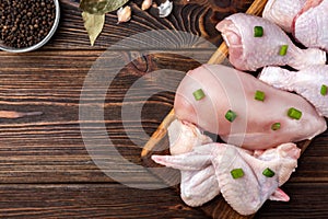 Raw chicken meat on dark wooden background