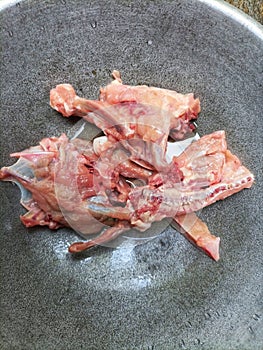 Raw chicken meat in a pan, ready to be cooked.