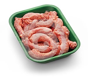 Raw chicken necks in a green tray over white background