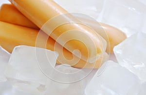 Raw chicken sausage stuffed cheese keeping for fresh on ice in white background