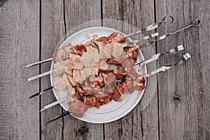 Raw chicken shish kebab with vegetables and spices. Top view. Free space for your text. Rustic style