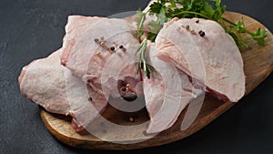 Raw chicken thigh on cutting board