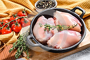 Raw chicken thigh fillet without skin. Farm poultry meat. White background. Top view