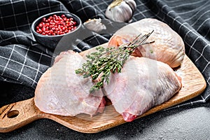 Raw chicken thigh, organic poultry meat. Black background. Top view