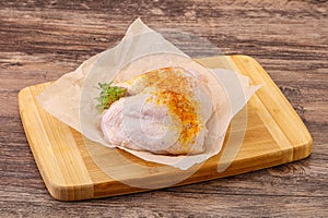 Raw chicken thigh with spices