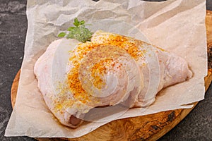 Raw chicken thigh with spices