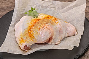 Raw chicken thigh with spices