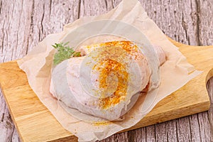 Raw chicken thigh with spices