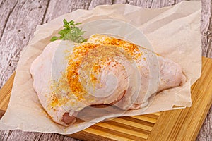 Raw chicken thigh with spices