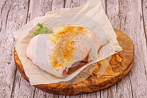 Raw chicken thigh with spices