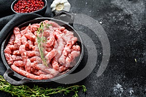 Raw chicken, Turkey ground meat in a pan. Organic forcemeat, mince. Black background. Top view. Copy space